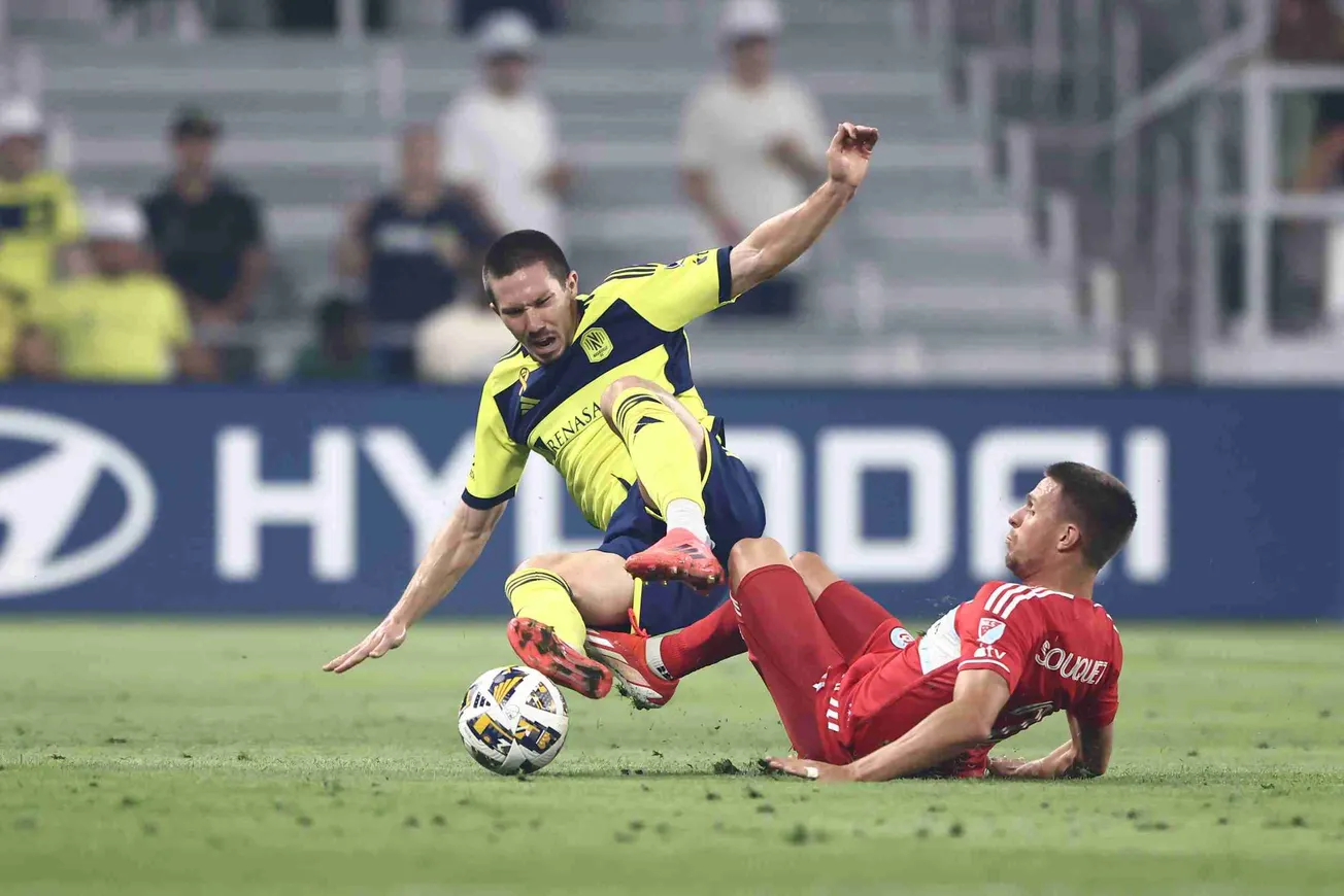 Sep 18, 2024; Nashville, Tennessee, USA; Nashville SC midfielder Alex Muyl (19) is slide tackled by Chicago Fire defender Arn