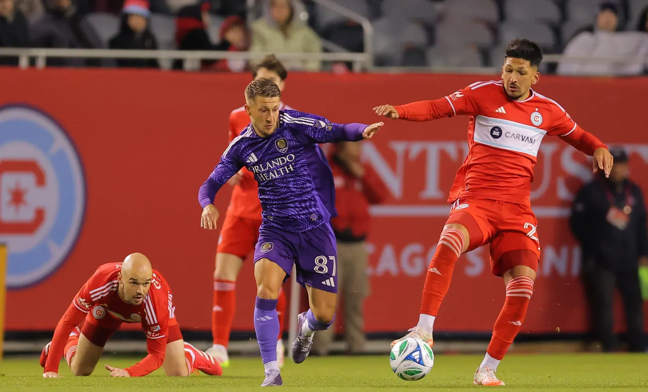 May 3, 2025; Chicago, Illinois, USA; Orlando City forward Duncan McGuire (13) and Chicago Fire FC defender Mauricio Pineda (2