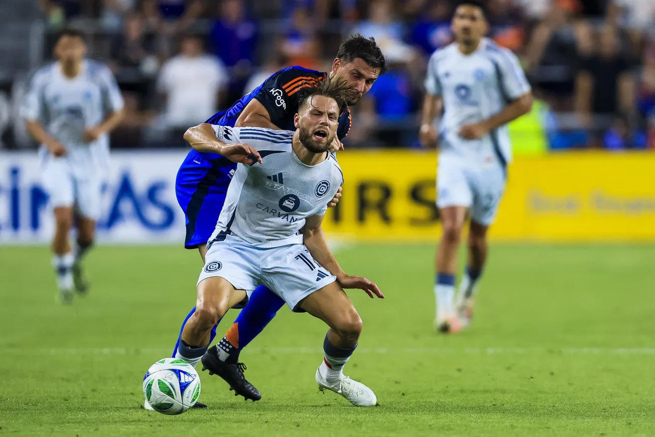 Jul 5, 2025; Cincinnati, Ohio, USA; FC Cincinnati defender Matt Miazga (21) battles for the ball against Chicago Fire FC forw