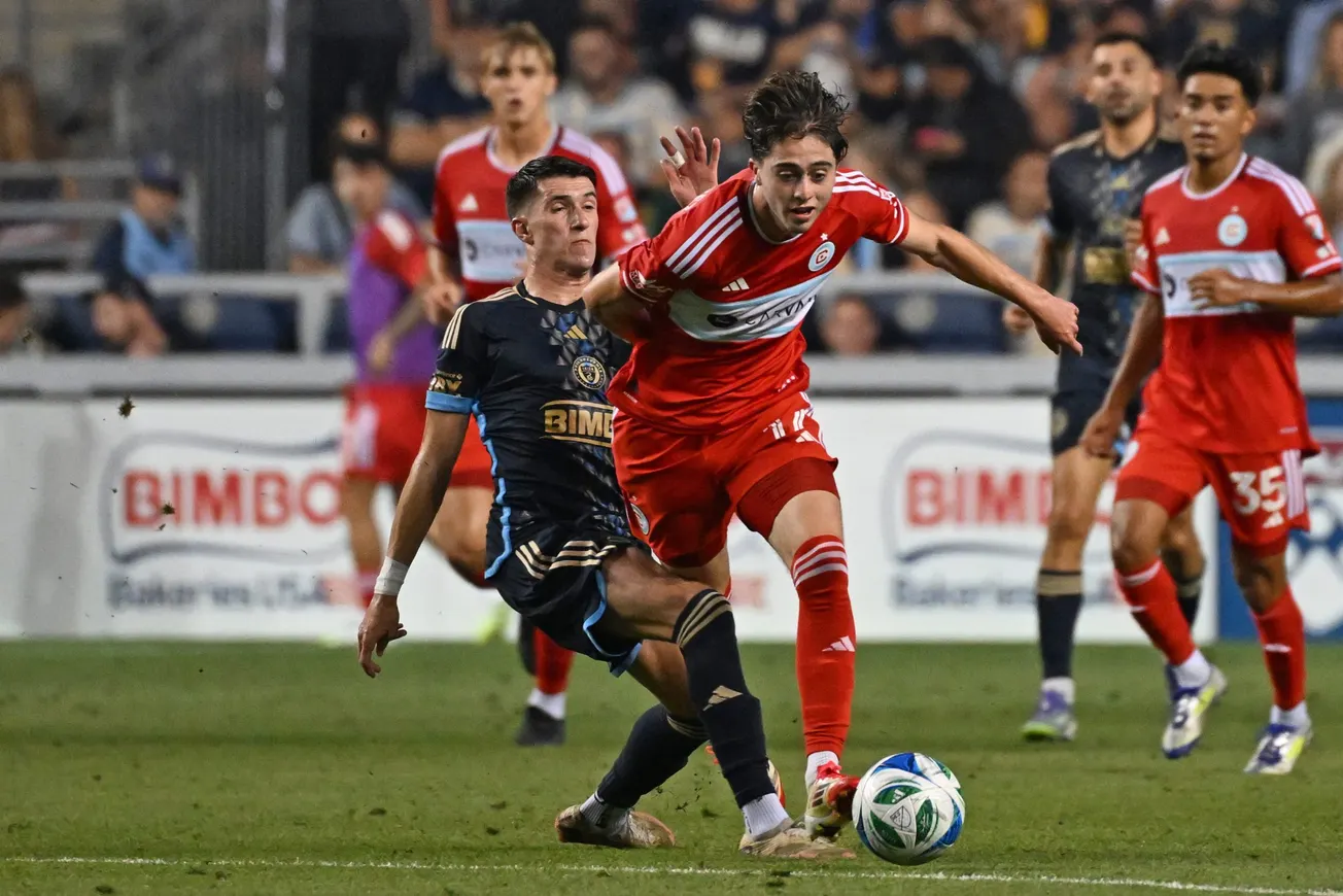 Aug 23, 2025; Chester, Pennsylvania, USA; Chicago Fire midfielder Brian Gutirrez (17) is tackled by Philadelphia Union midfi