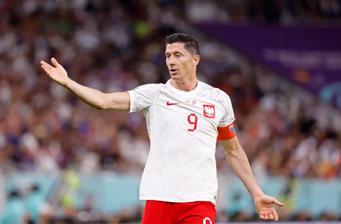 Robert Lewandowski (9) reacts after a play against France during the first half of a round of sixteen match in the 2022 FIFA World Cup at Al Thumama Stadium.