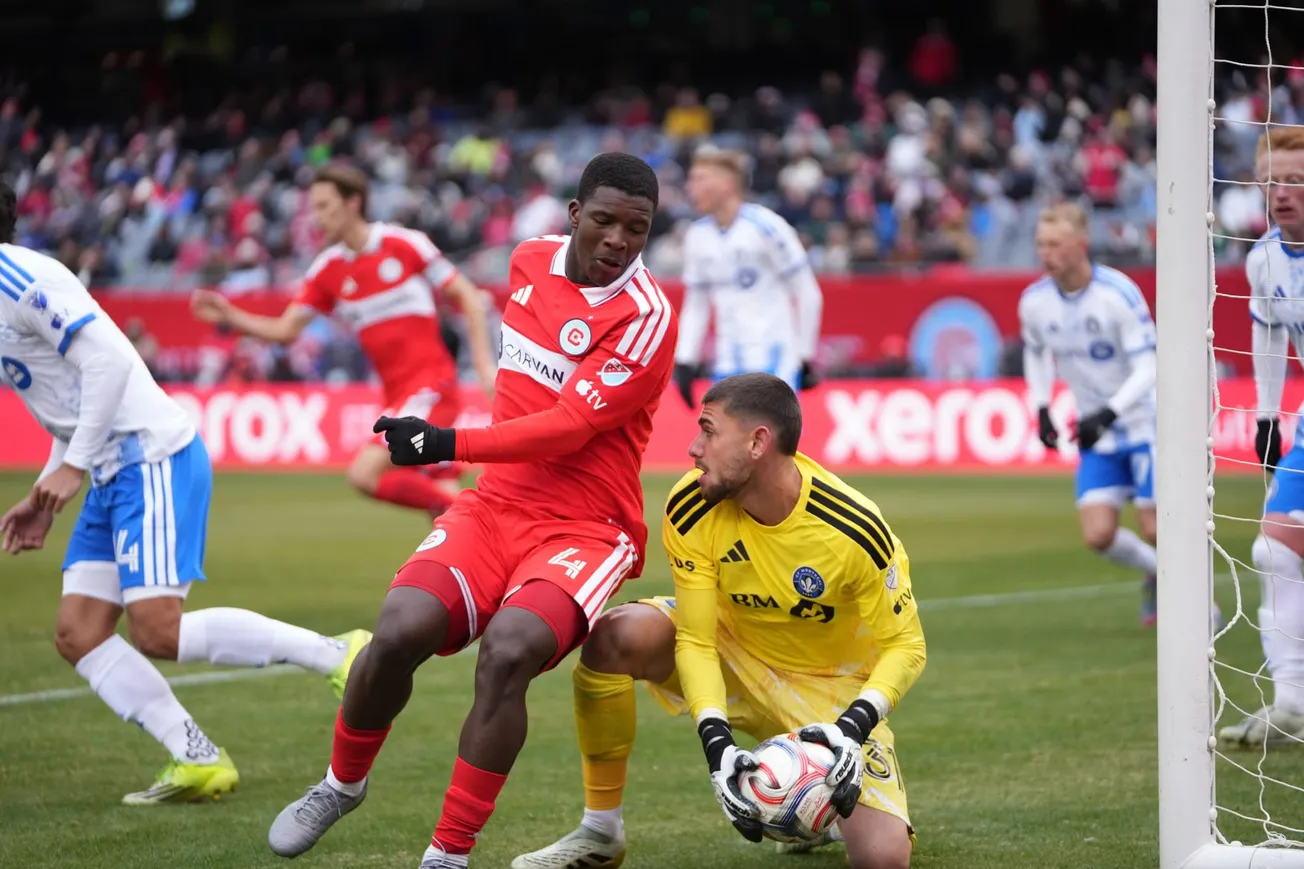 Chicago Fire's Mbekezeli Mbokazi (4) challenges Tomás Gillier of CF Montréal at a soccer game in soldier Field.