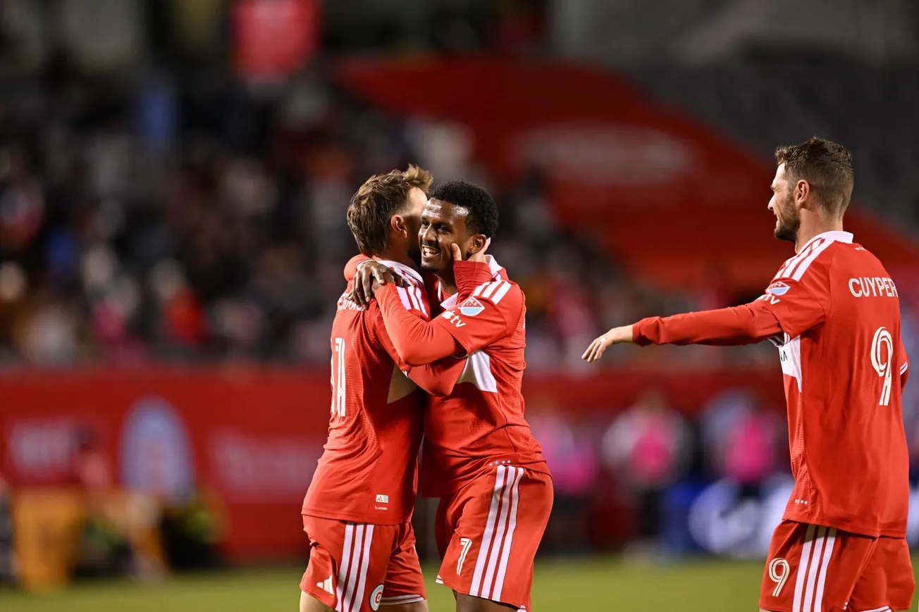 Maren Haile-Selassie, Hugo Cuypers and Philip Zinckernagel celebrate after scoring at Soldier Field