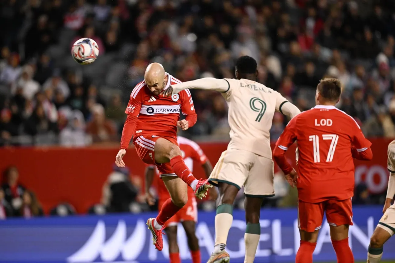 Andrew Gutman heads the ball