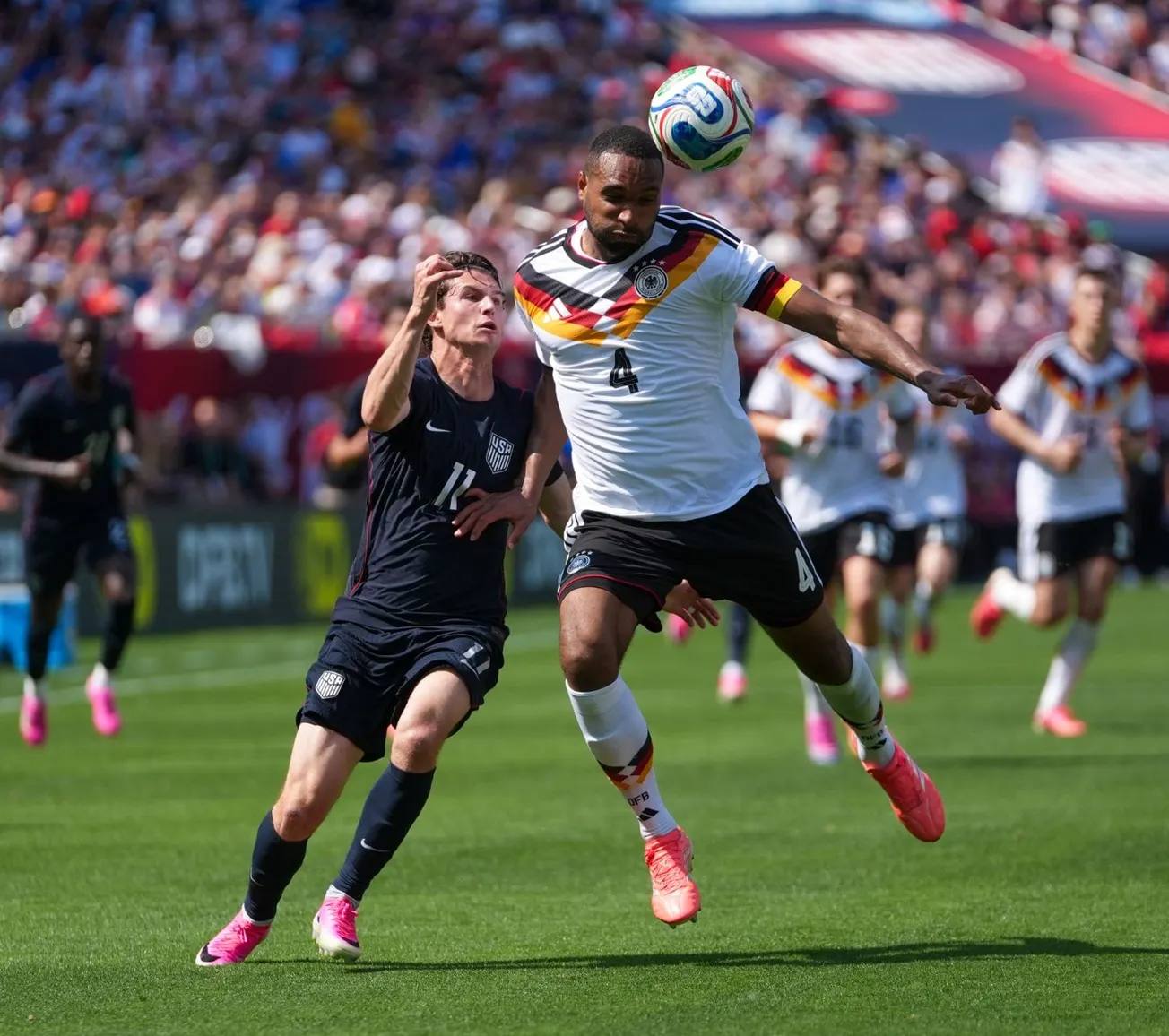 Germany's Jonathan Tah and the USMNT's Brenden Aaronson battle for the ball at the international friendly ahead of the 2026 World Cup.