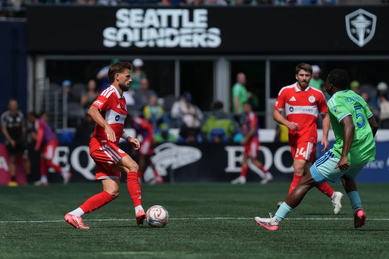 Philip Zinckernagel and Jonathan Dean of the Chicago Fire play against Nouhou of the Seattle Sounders