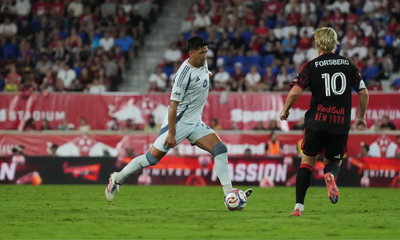 Mauricio Pineda plays the ball against New York Red Bulls' Emil Forsberg at Sports Illustrated Stadium