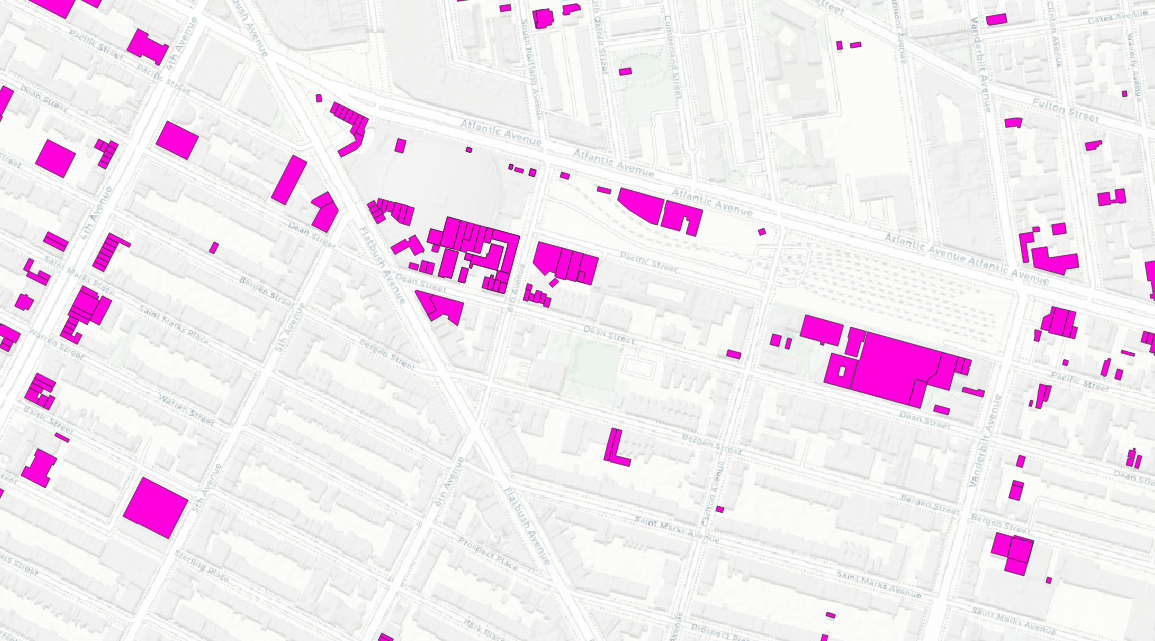 A grey map with bright pink building footprints from buildings that have been demolished.
