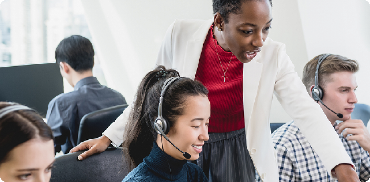 Team of call center employees with headsets collaborating with a leader, highlighting the human side of frontline AI disruptions