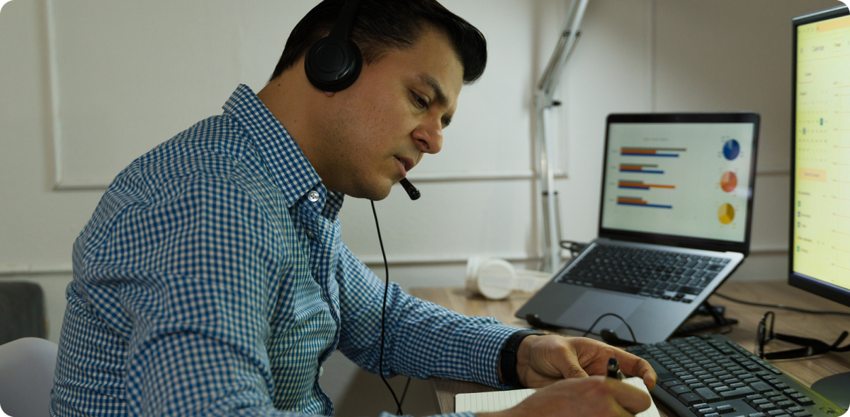 Frontline leader reviewing data while on a call, reflecting how empathy impacts communication at work