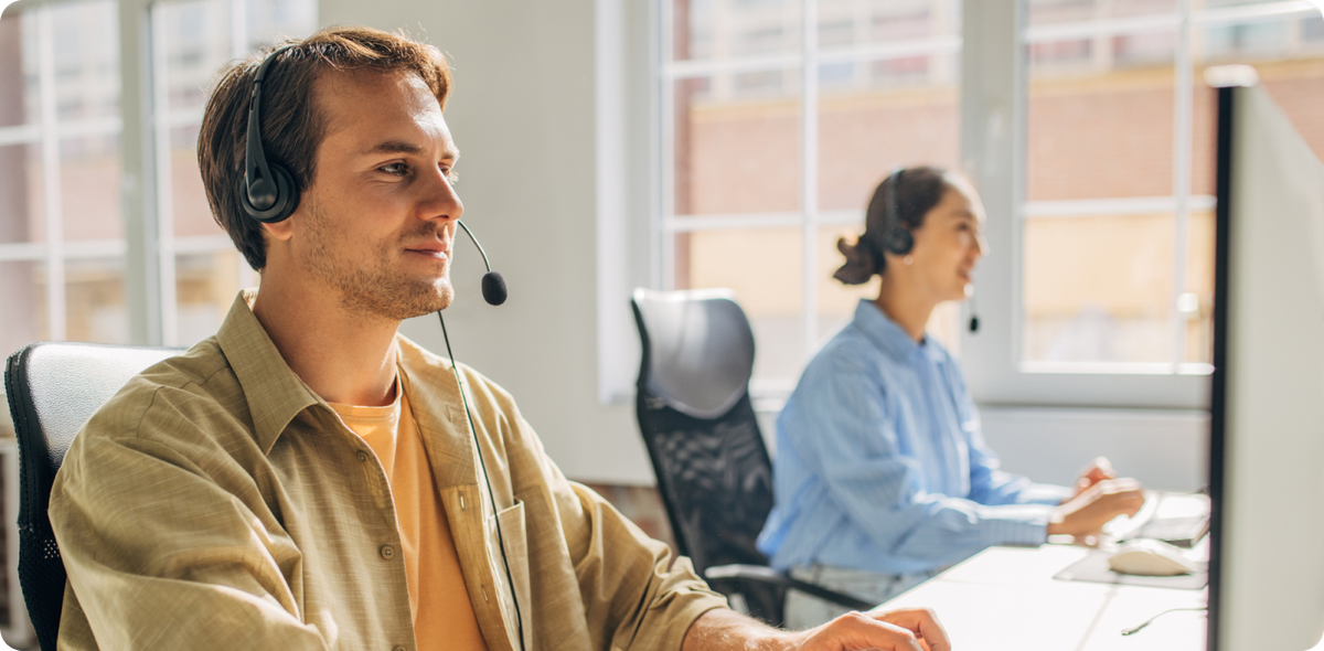 Contact center agents working with headsets, showing how career growth and support reduce frontline attrition.