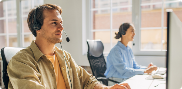 Contact center agents working with headsets, showing how career growth and support reduce frontline attrition.