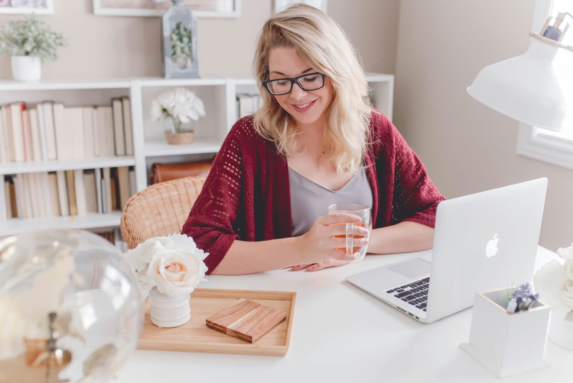 girl smiling in front of laptop - how much youtube shorts pay for 1,000 views