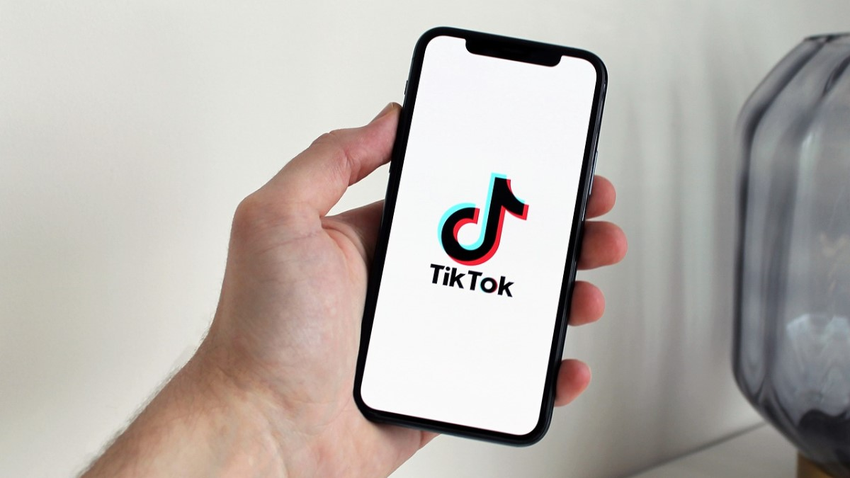 person holding phone - Why Can't I Download TikTok Videos