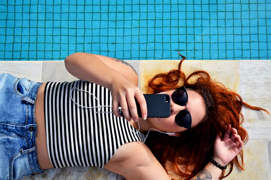 woman lying beside a pool - How to Download YouTube Videos Without YouTube Premium