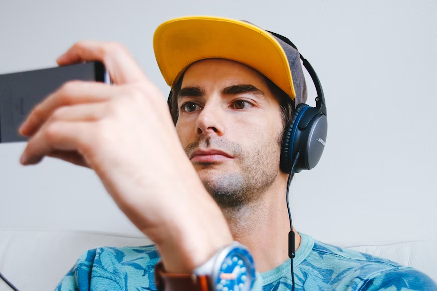 man using headphones - Can You Download YouTube Videos to Watch Offline
