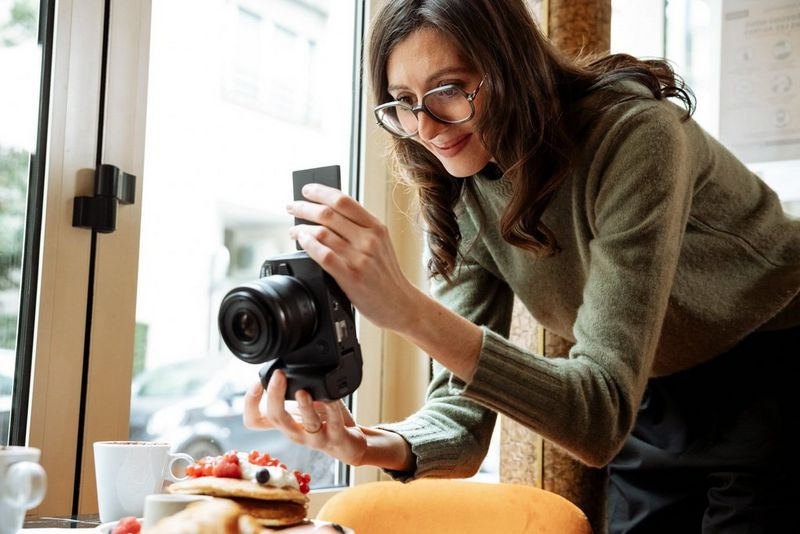 woman using a professional camera - Facebook Reels vs Instagram Reels