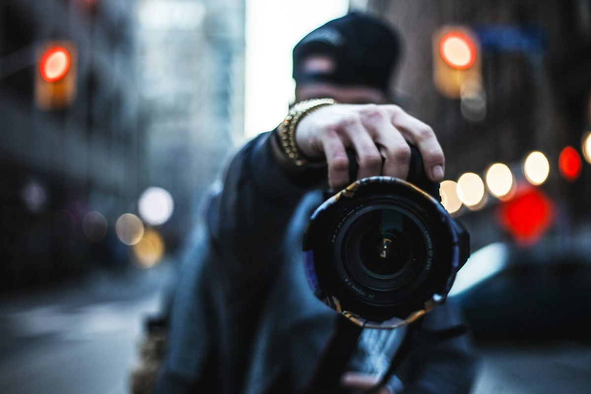 man holding a camera - How To Create Video Content For Social Media