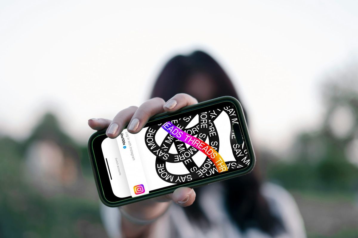 woman holding a phone - How to Promote Instagram Page