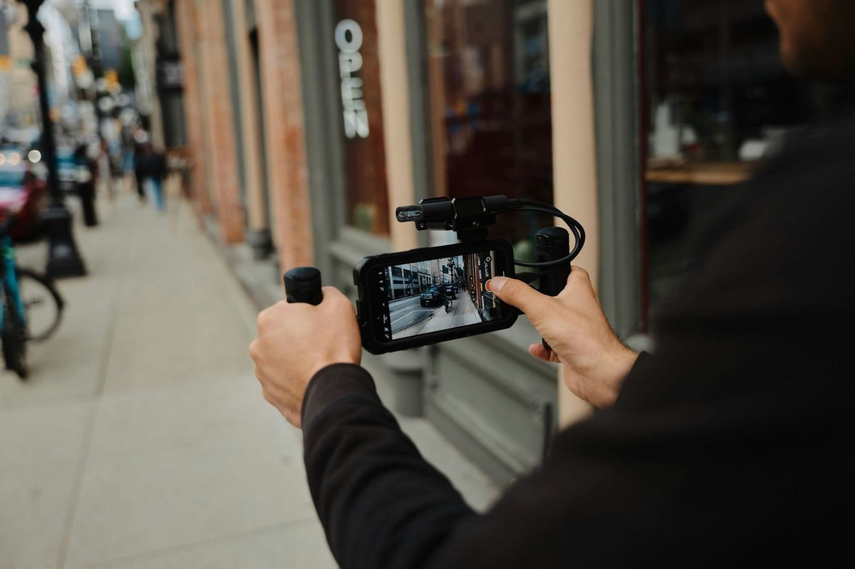 man recording a video - How to Make a Reel on Instagram With Photos