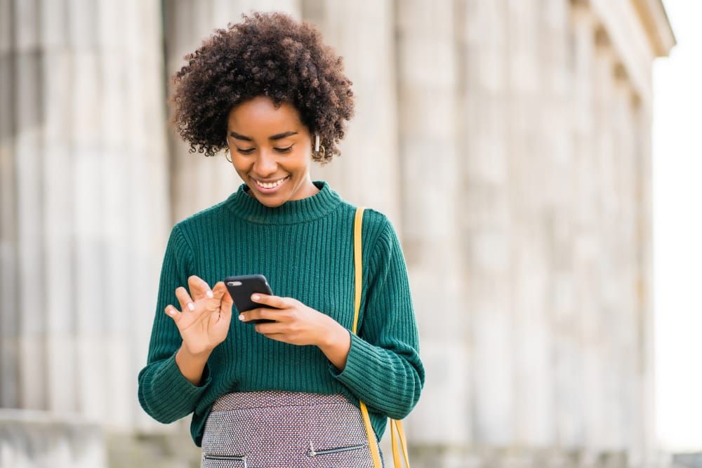 woman using a phone - How to Download YouTube Videos on Android