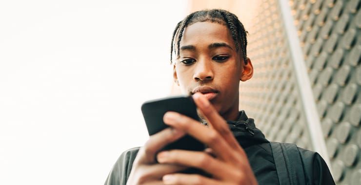 boy using a phone - Why Are My Instagram Reels Not Getting Views