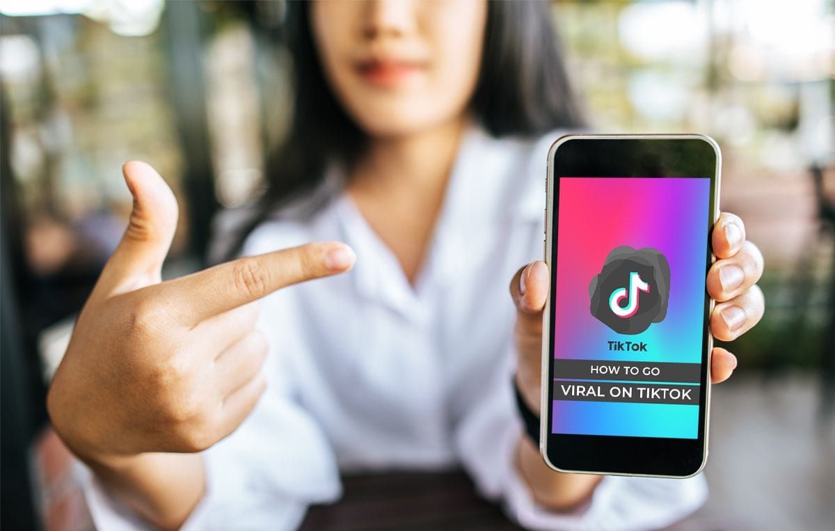 woman holding a phone - What Is Considered Viral on TikTok