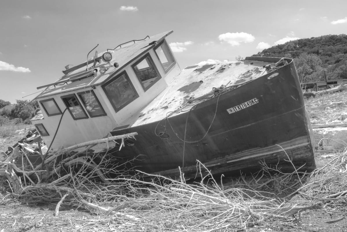 During the 2011 Texas drought, many of the waterways dried up across the state. This boat was left to sit in the middle of what is normally a branch of Lake Travis, part of the Colorado River. Image: Erik Ellison.