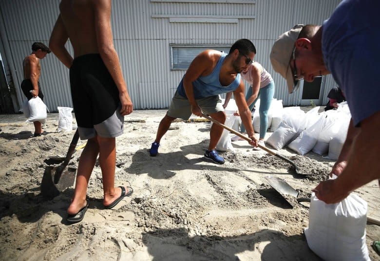 Residents fill sand bags as they prepare for the arrival of Hurricane Florence in September 2018 in Wrightsville Beach, N.C.