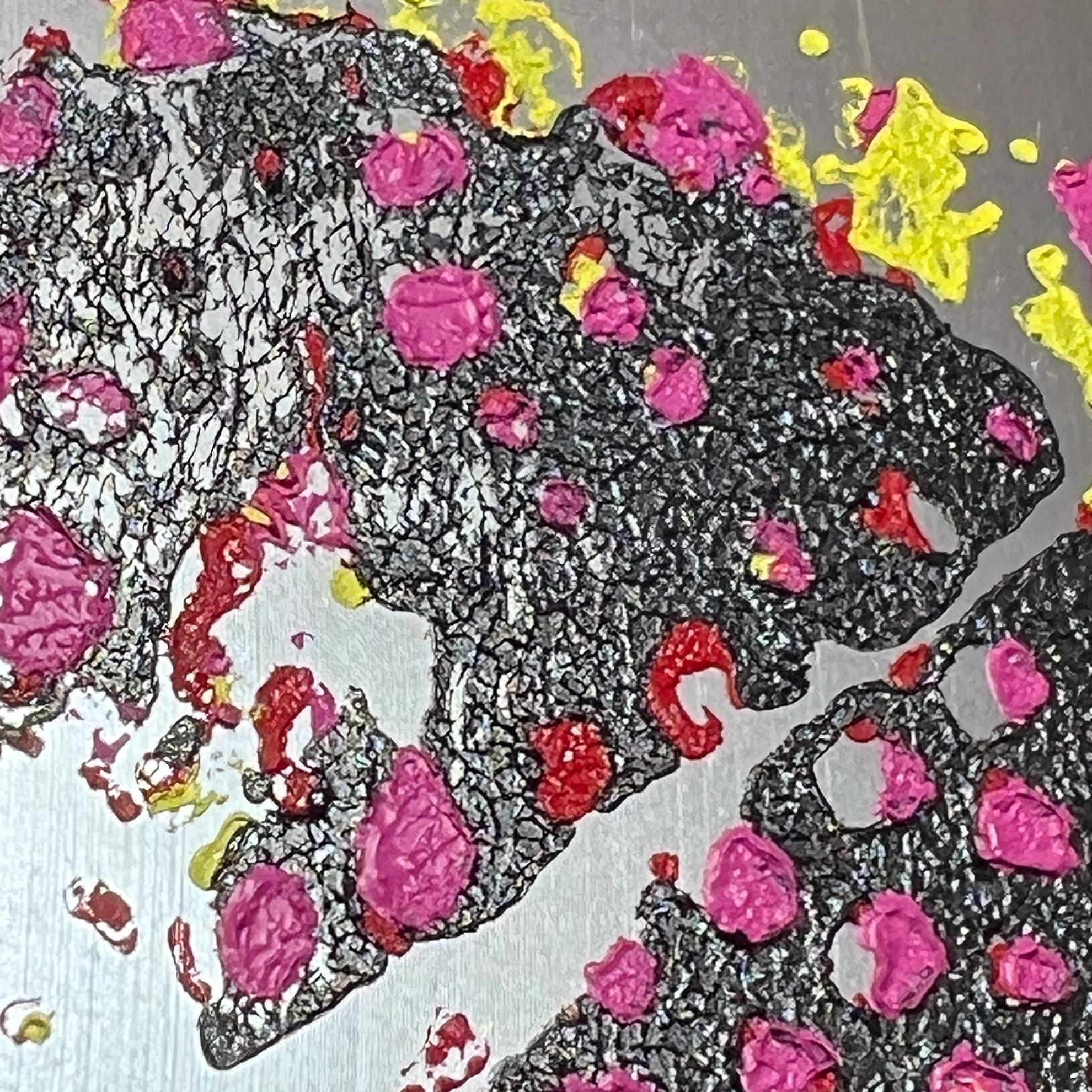 Close-up detail of a painting showing a cracked black surface with pink and yellow pigments bleeding through. 