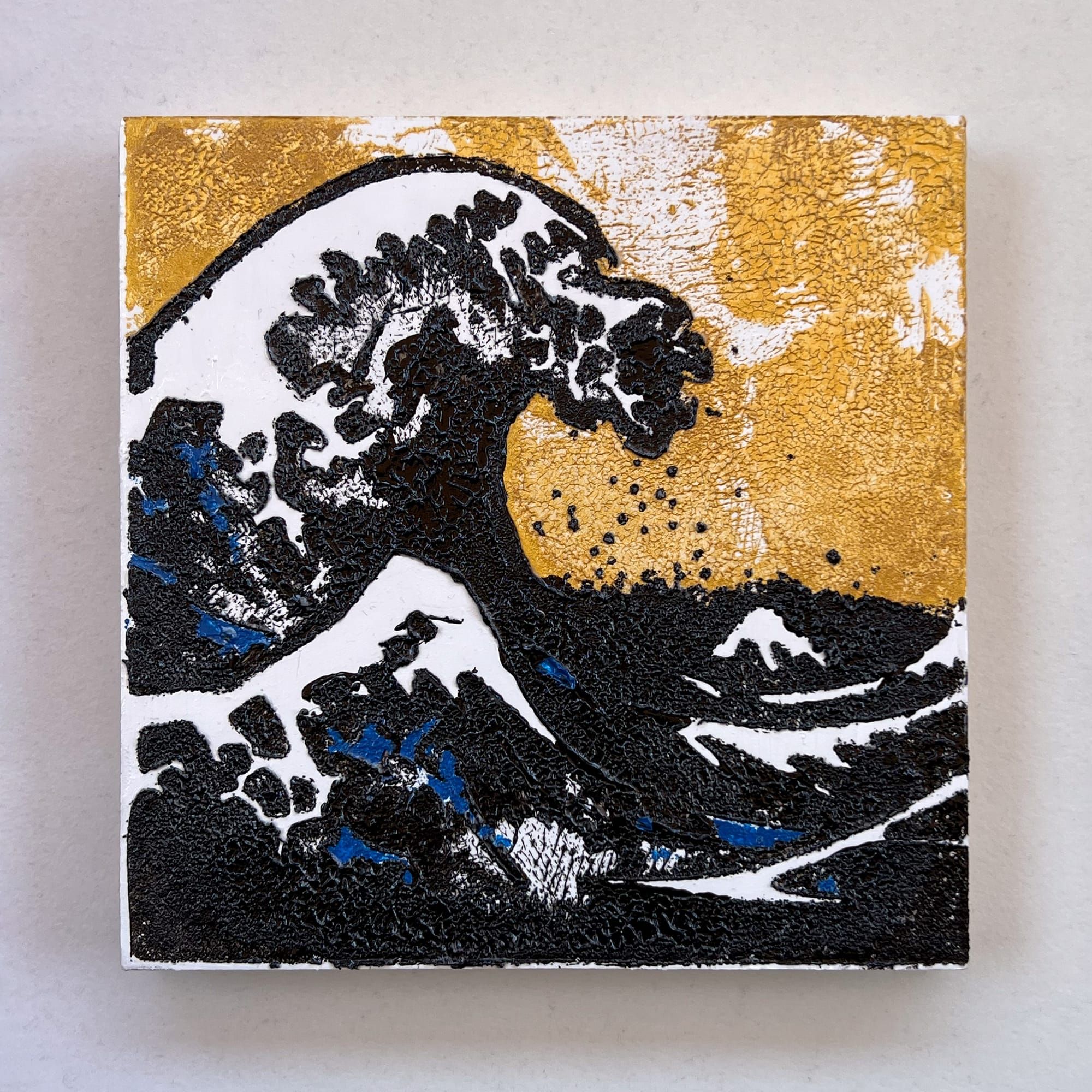6x6 acrylic painting of a stylized Great Wave with thick black impasto, cobalt blue accents, and a metallic gold background on a cradled wood panel.