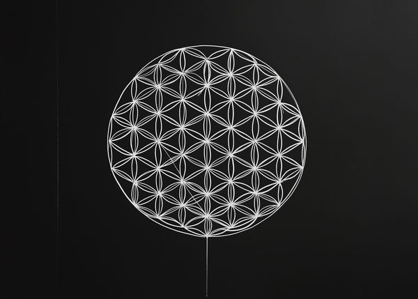 A simple black-and-white line drawing of the Flower of Life, a symbol from sacred geometry