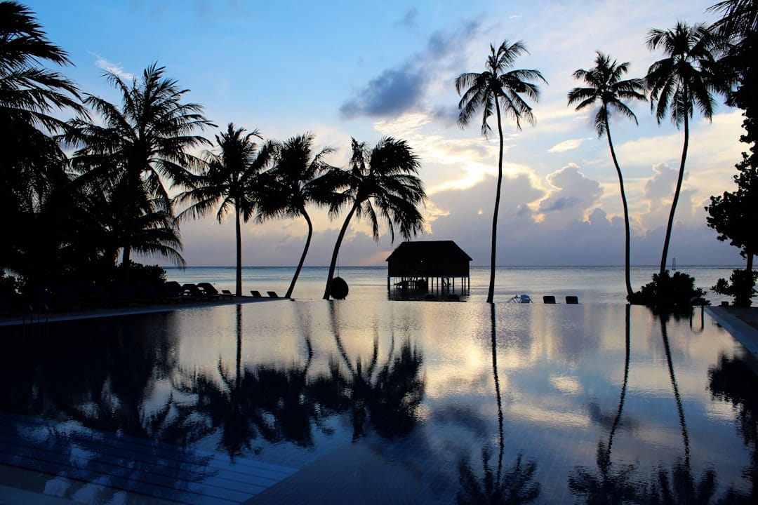 Overwater villas on stilts above a turquoise Maldives lagoon