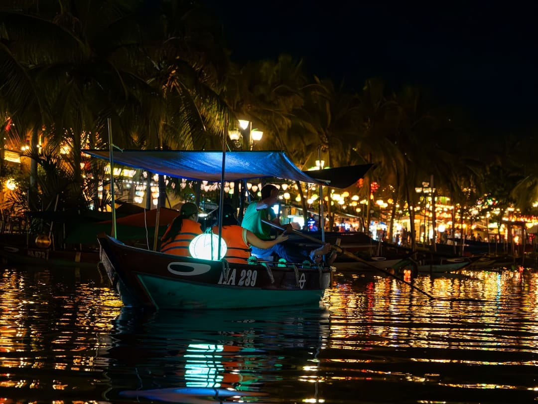 Lantern-lit wooden boats on the Thu Bon river in Hoi An at night