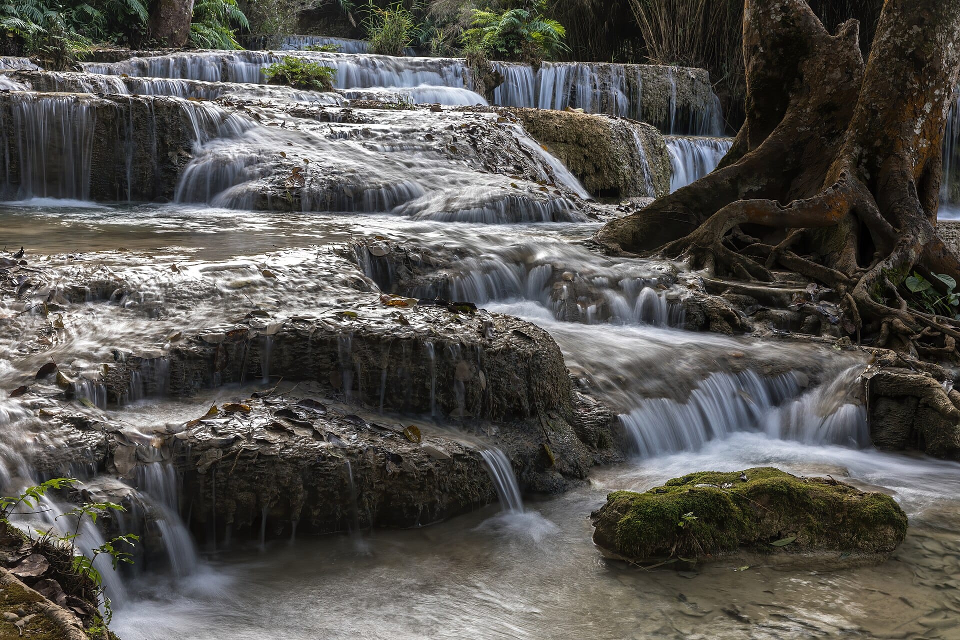 The turquoise tiered pools of Kuang Si Falls near Luang Prabang