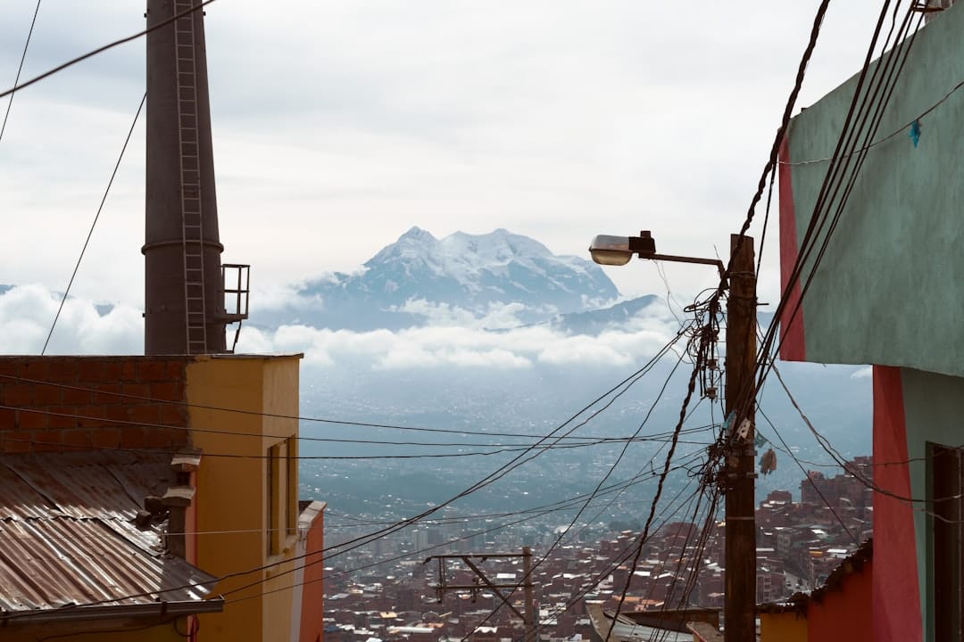 Panorama of La Paz spilling down its canyon with Illimani in the distance