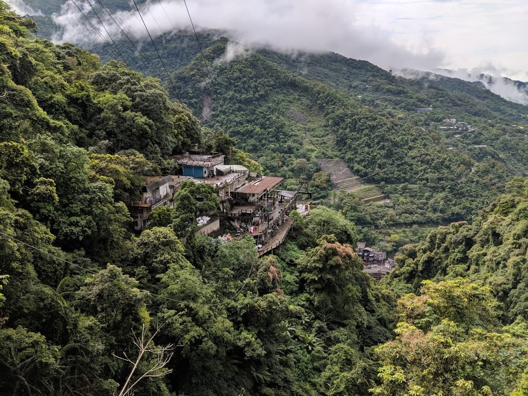 A cable-car gondola crossing forested green hills in Taiwan
