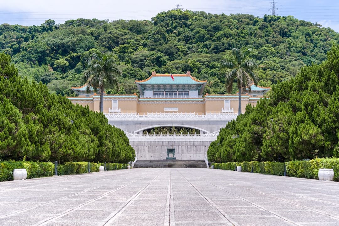 The National Palace Museum building set against green mountains in Shilin, Taipei