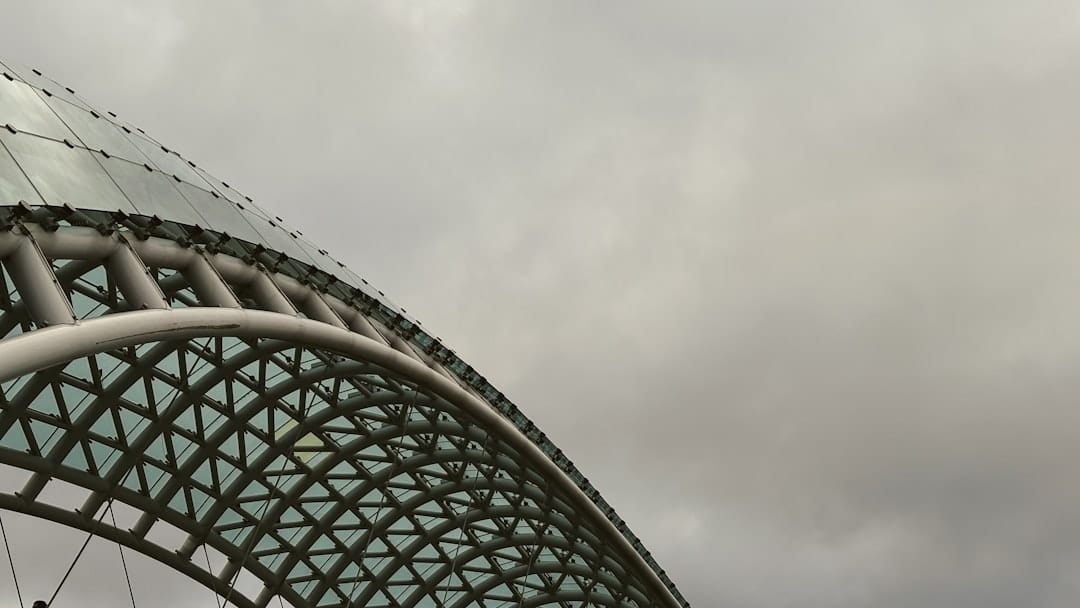 The glass and steel Bridge of Peace arcing over the Mtkvari river in Tbilisi