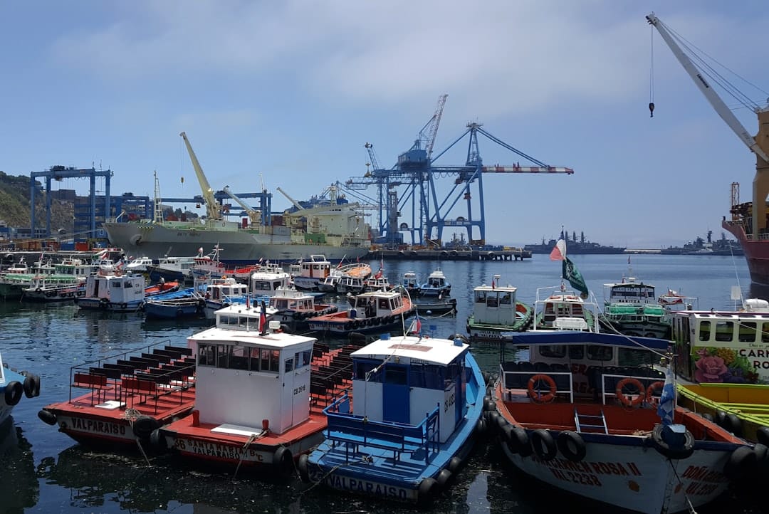 Colorful boats moored at Muelle Prat pier in Valparaíso harbor