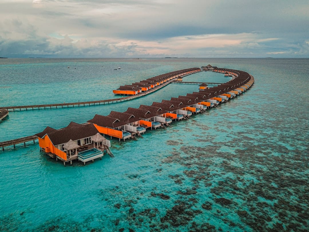Overwater villas on stilts above a turquoise Maldives lagoon