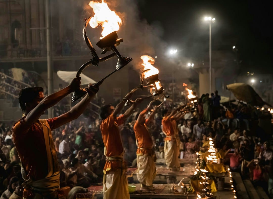 Priests perform the evening Ganga Aarti with fire lamps at a Varanasi ghat