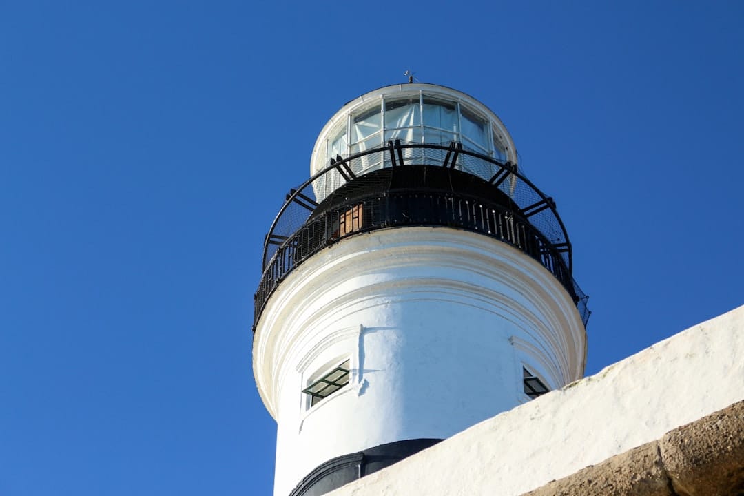 The black and white Farol da Barra lighthouse at the tip of the peninsula in Salvador