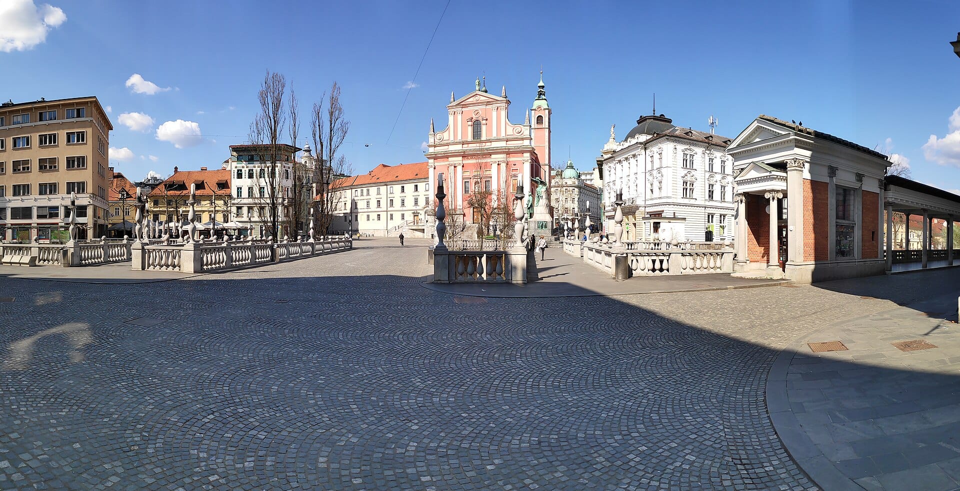 Prešeren Square with the pink Franciscan Church and Plečnik's Triple Bridge