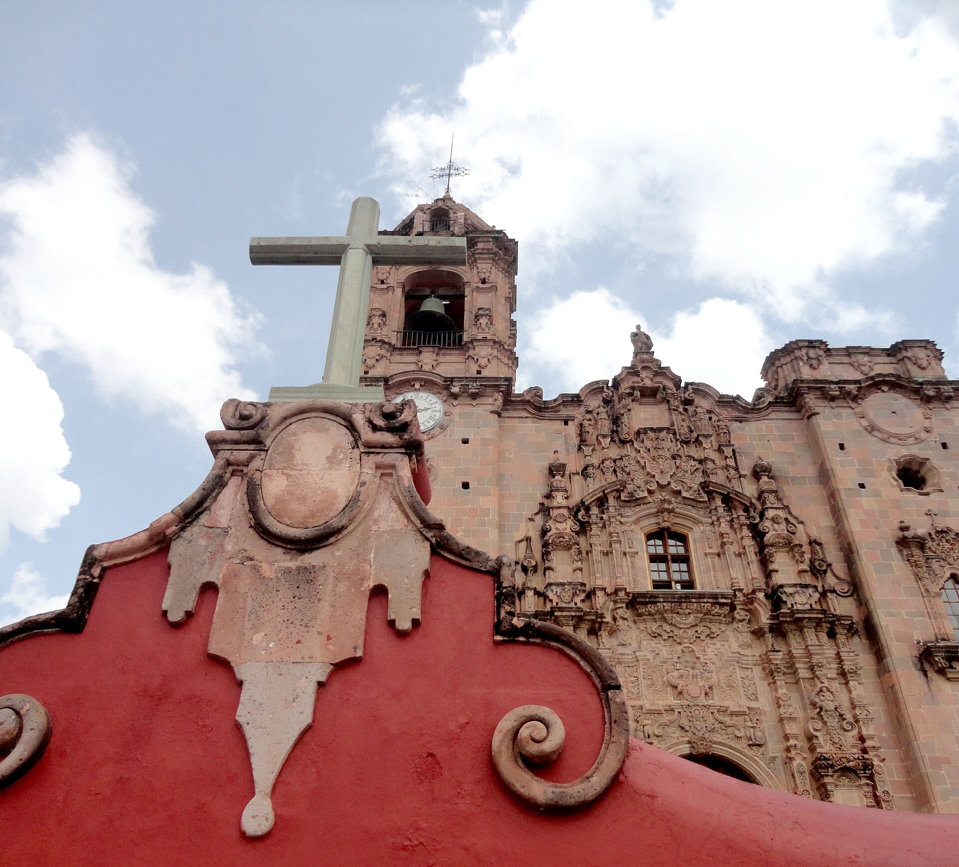 The ornate pink-stone Churrigueresque facade of the Templo de San Cayetano at La Valenciana