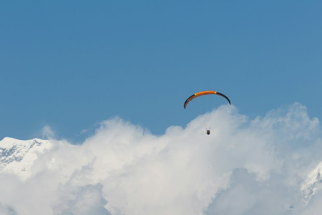 A tandem paraglider in the skies above the Pokhara valley
