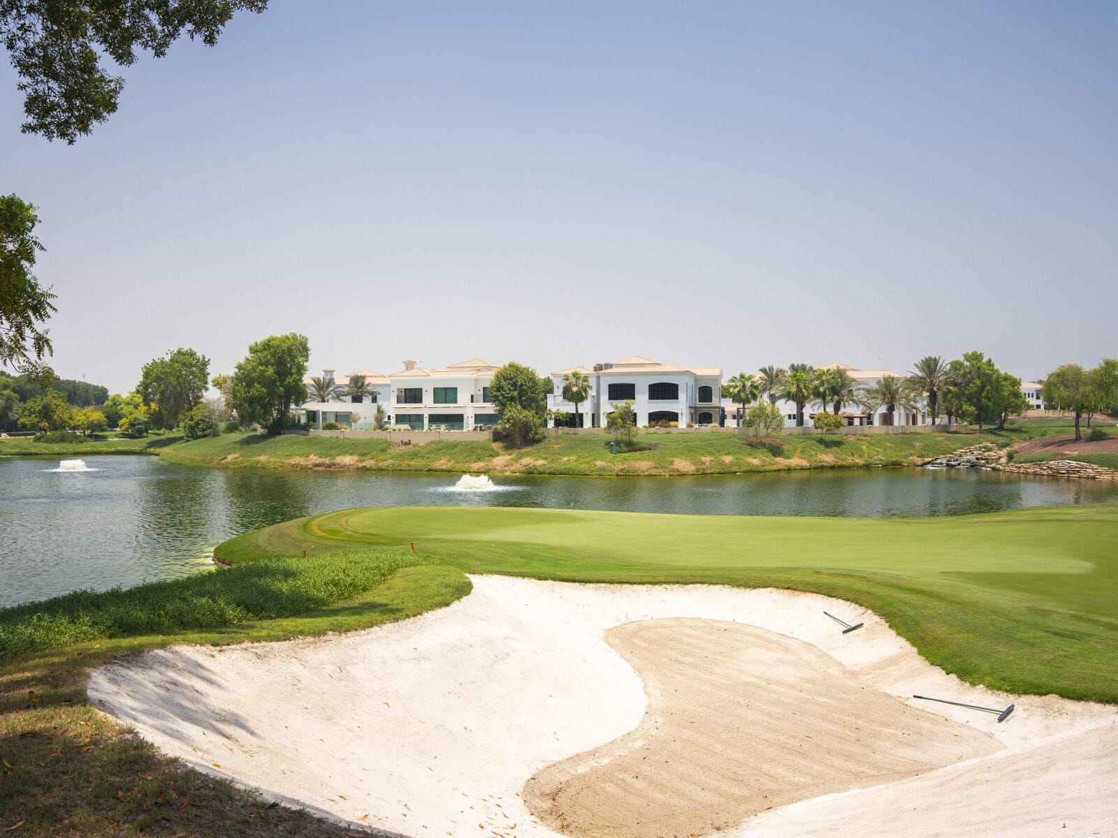 Bunker and lake on the Earth course at Lime Tree Valley, Jumeirah Golf Estates