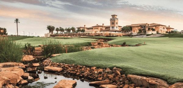 Jumeirah Golf Estates clubhouse exterior at golden hour, JGE