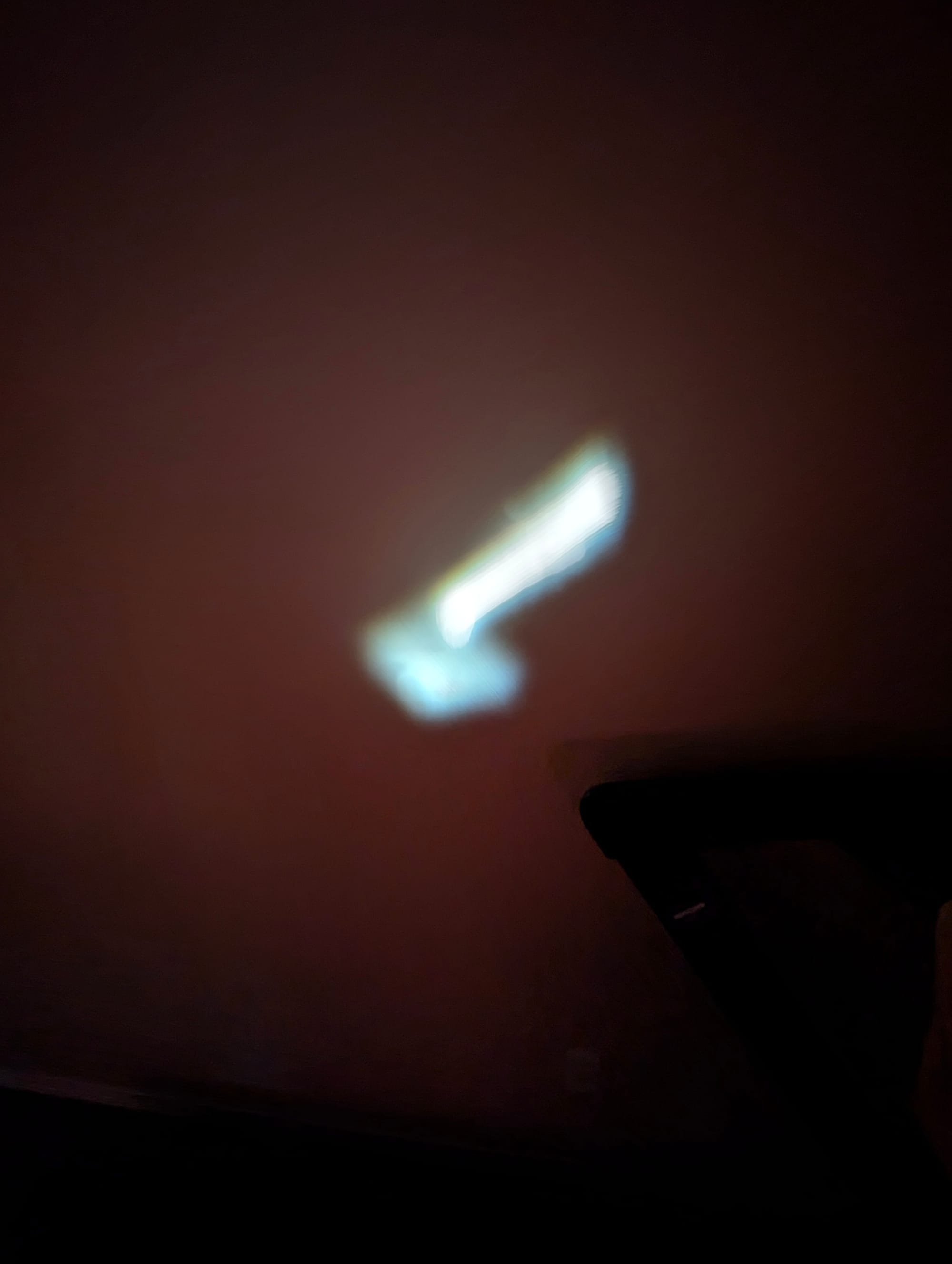 a clean light trail, drawn by pointing the flashlight at the lens and moving it while the phone stays still