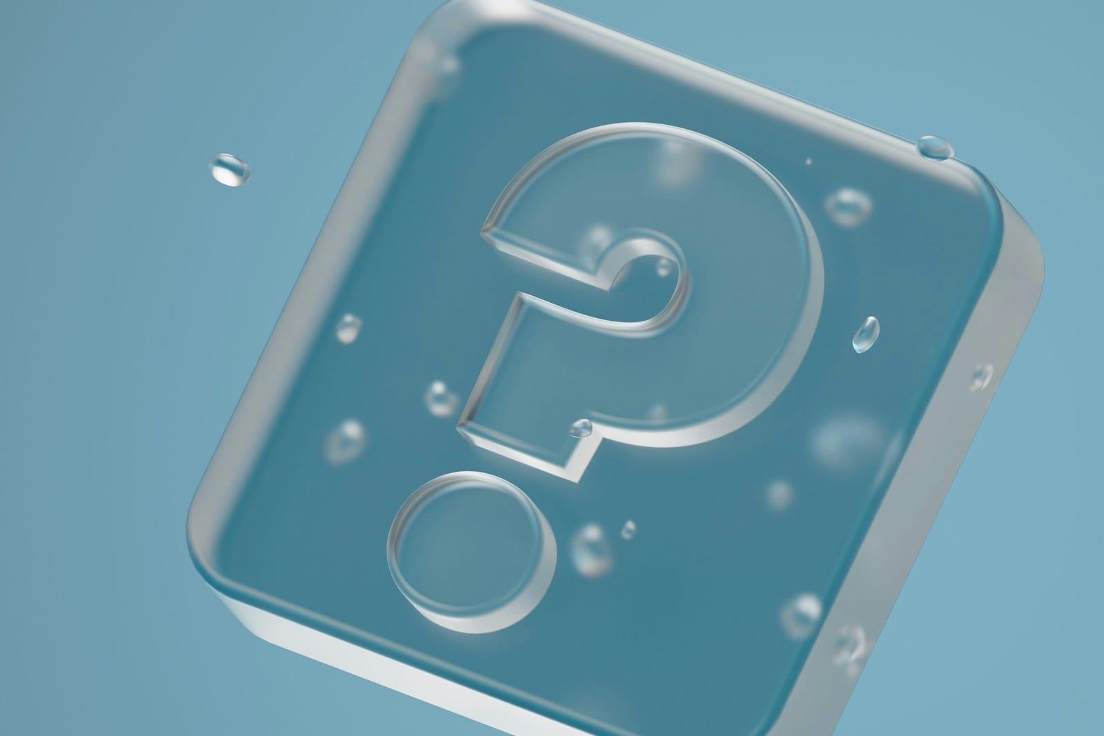 A translucent question-mark icon suspended in water with floating droplets.